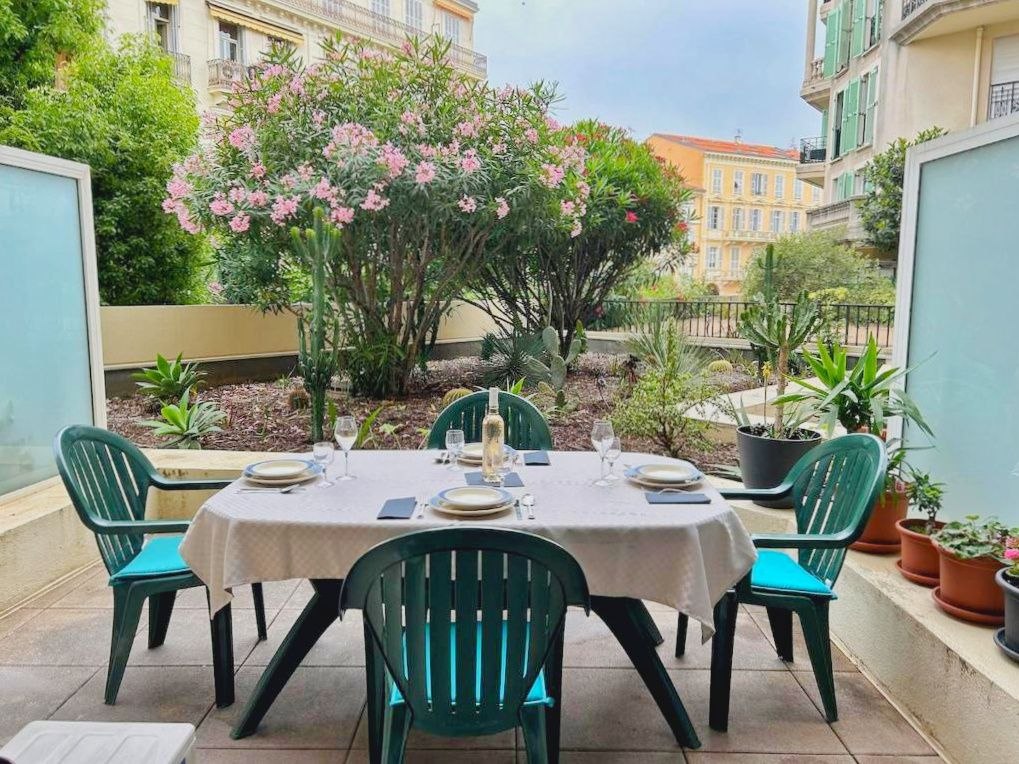 Private terrace with outdoor dining table and garden view in central Menton