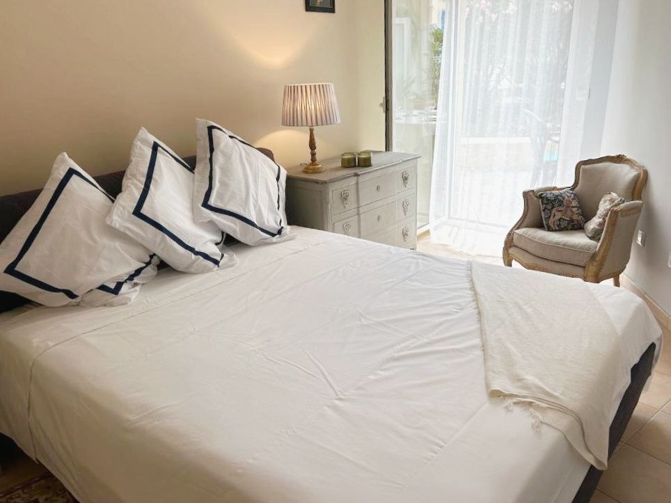 Comfortable bedroom with double bed, armchair and soft lighting