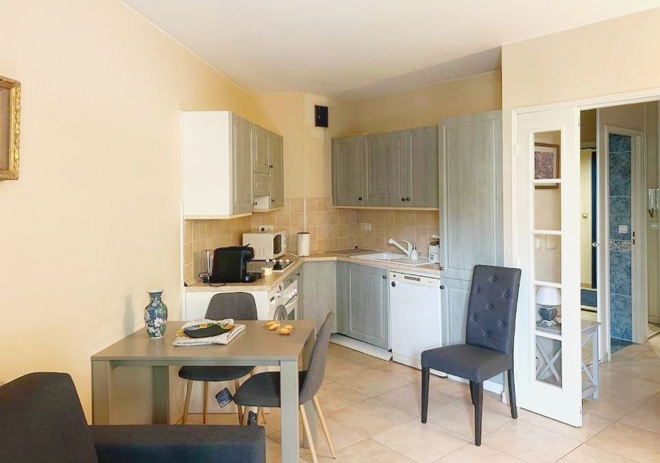 Dining area beside an equipped kitchen in the beachside apartment