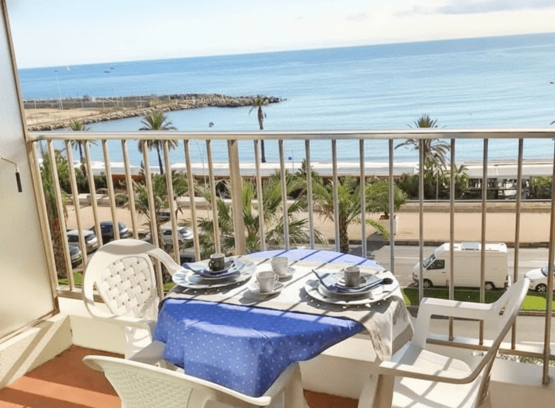 Private balcony with breakfast table overlooking the Mediterranean sea in Menton