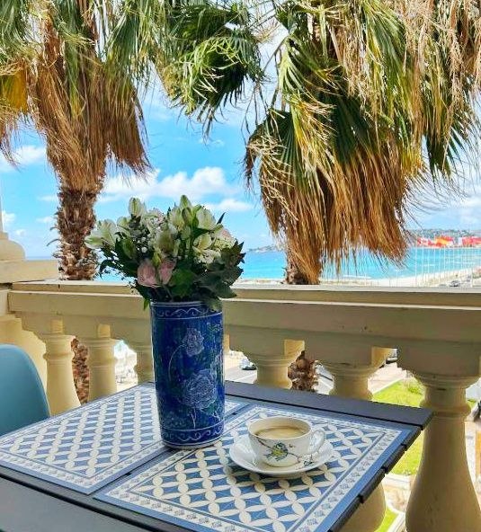Private balcony table with coffee and Mediterranean sea view in Menton