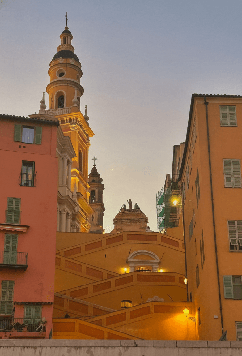 Colourful old town buildings and church tower in Menton